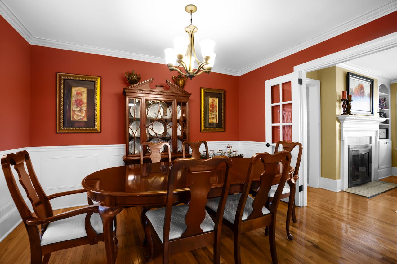Services Charming dining room featuring elegant wooden furniture and a classic chandelier.